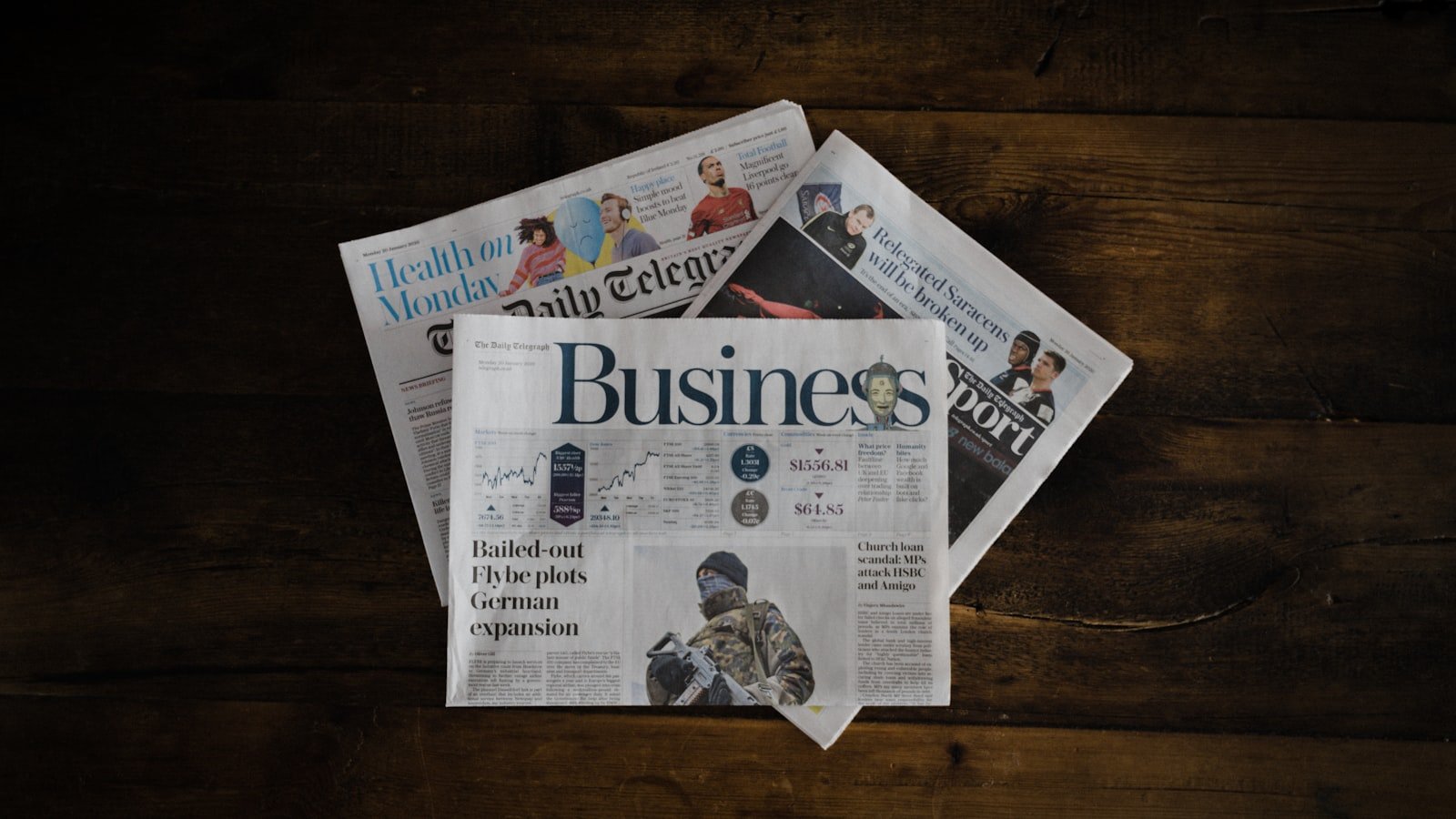A stack of newspapers representing the press mentions and digital PR coverage that build off-page SEO authority for local businesses