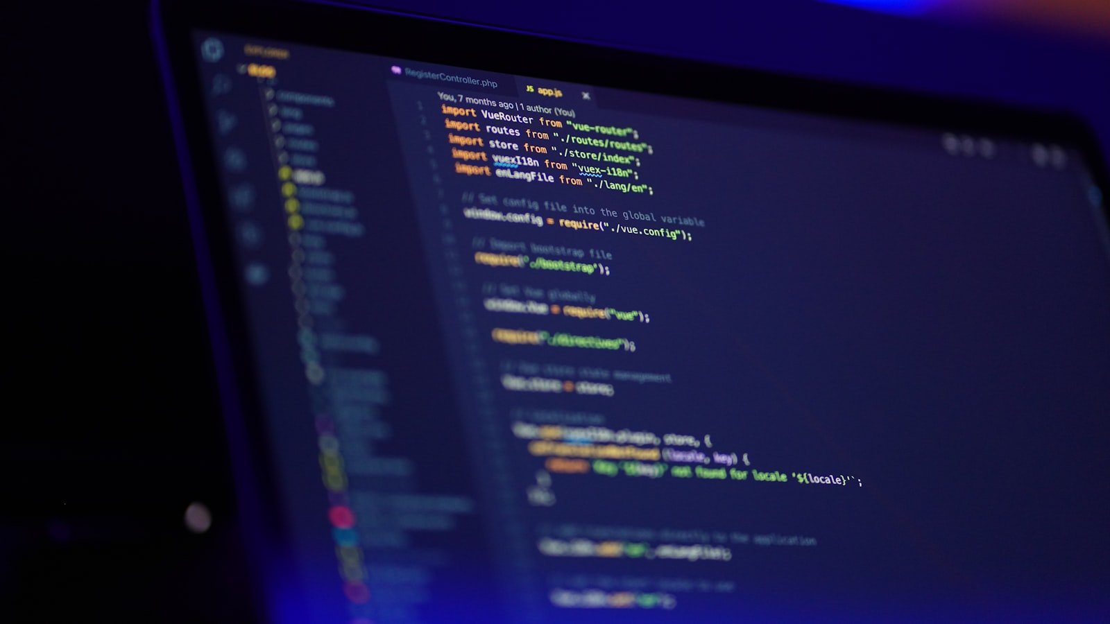 A laptop screen displaying colorful JSON-LD structured data code, representing schema markup implementation for a local business website