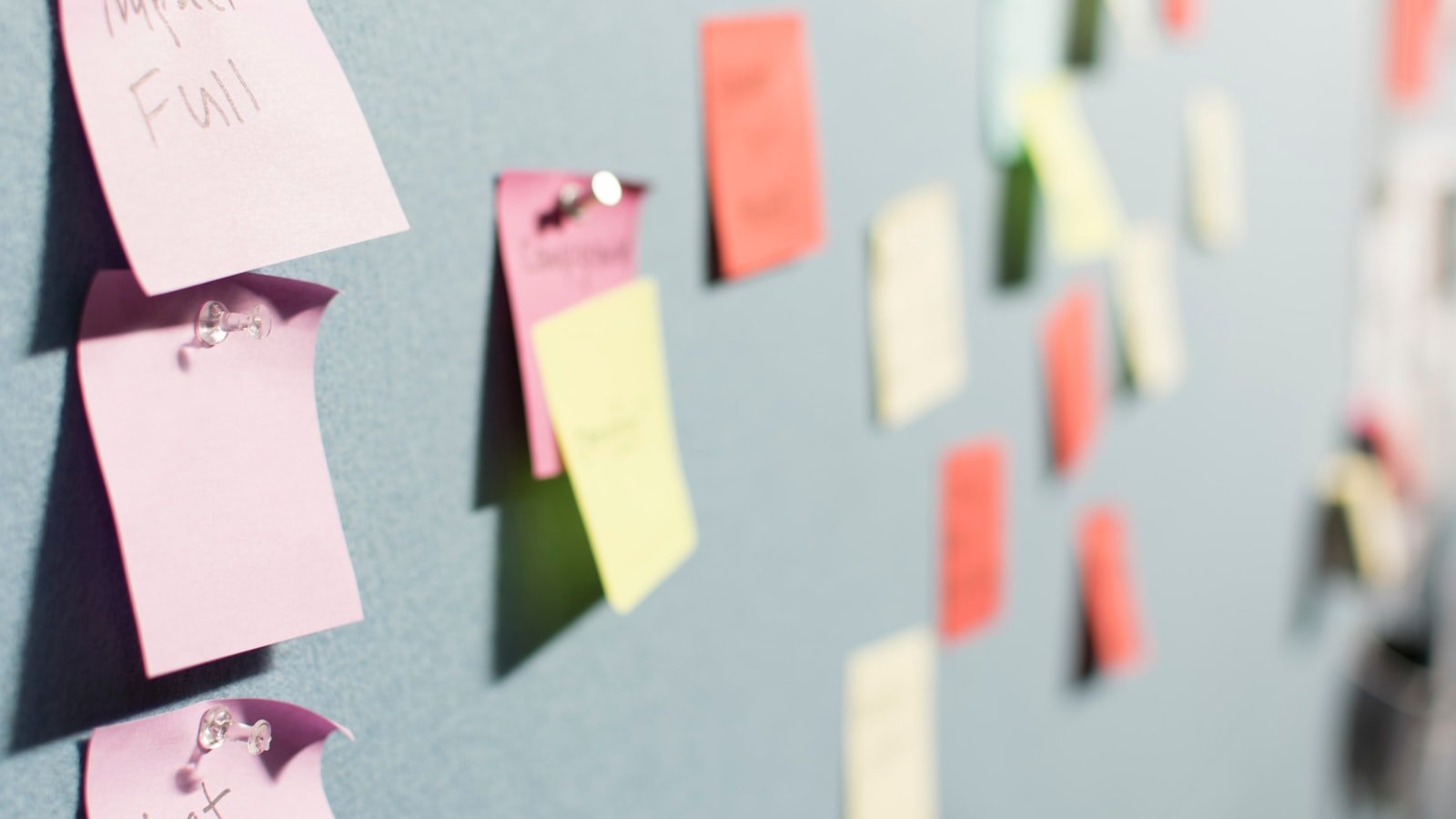 Colorful sticky notes arranged on a planning board, representing a small business content calendar for consistent SEO blogging