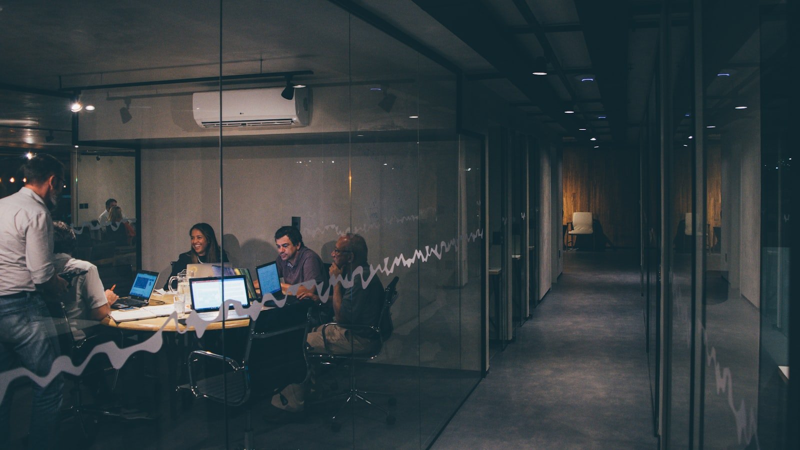 A small marketing team collaborating around a table during a strategy meeting
