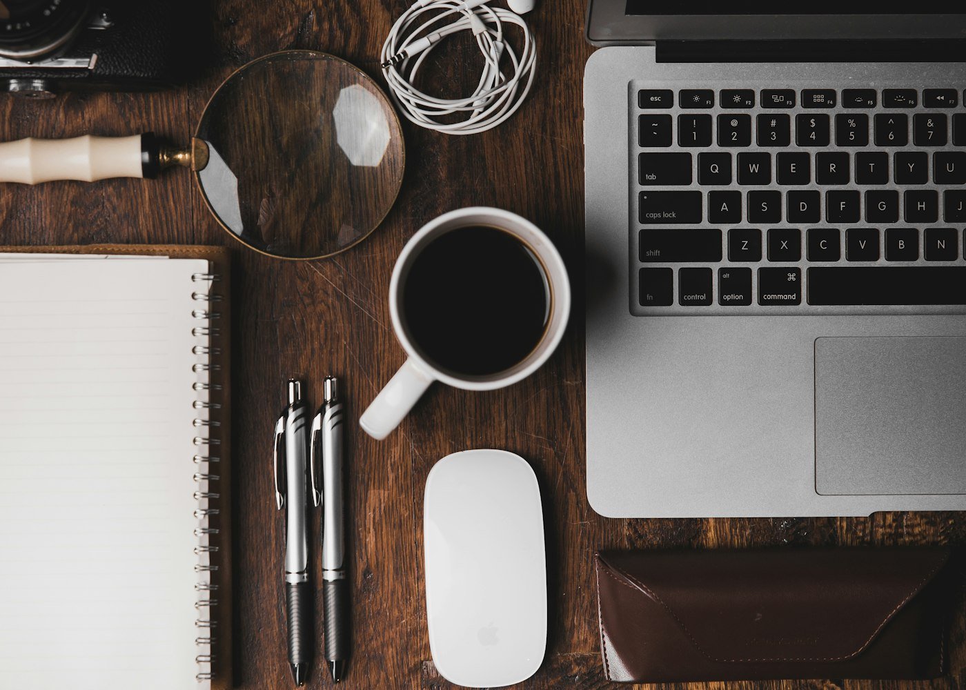 A laptop and a cup of coffee on a small desk, representing Marketivv's scrappy 2019 founding in Los Angeles